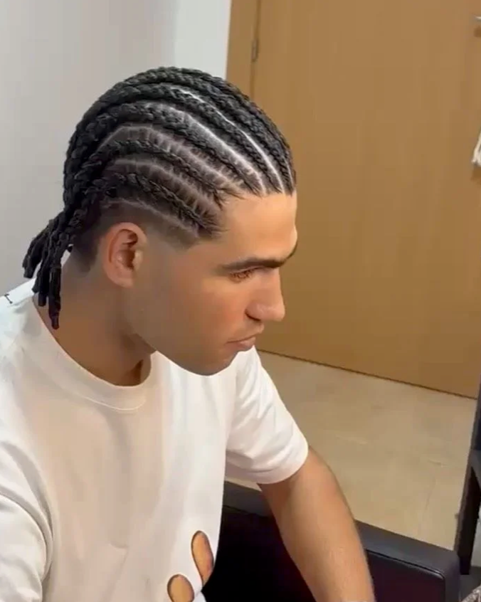 The Spanish tennis star surprised fans by swapping his signature hairstyle for sleek boxer braids during his summer break.