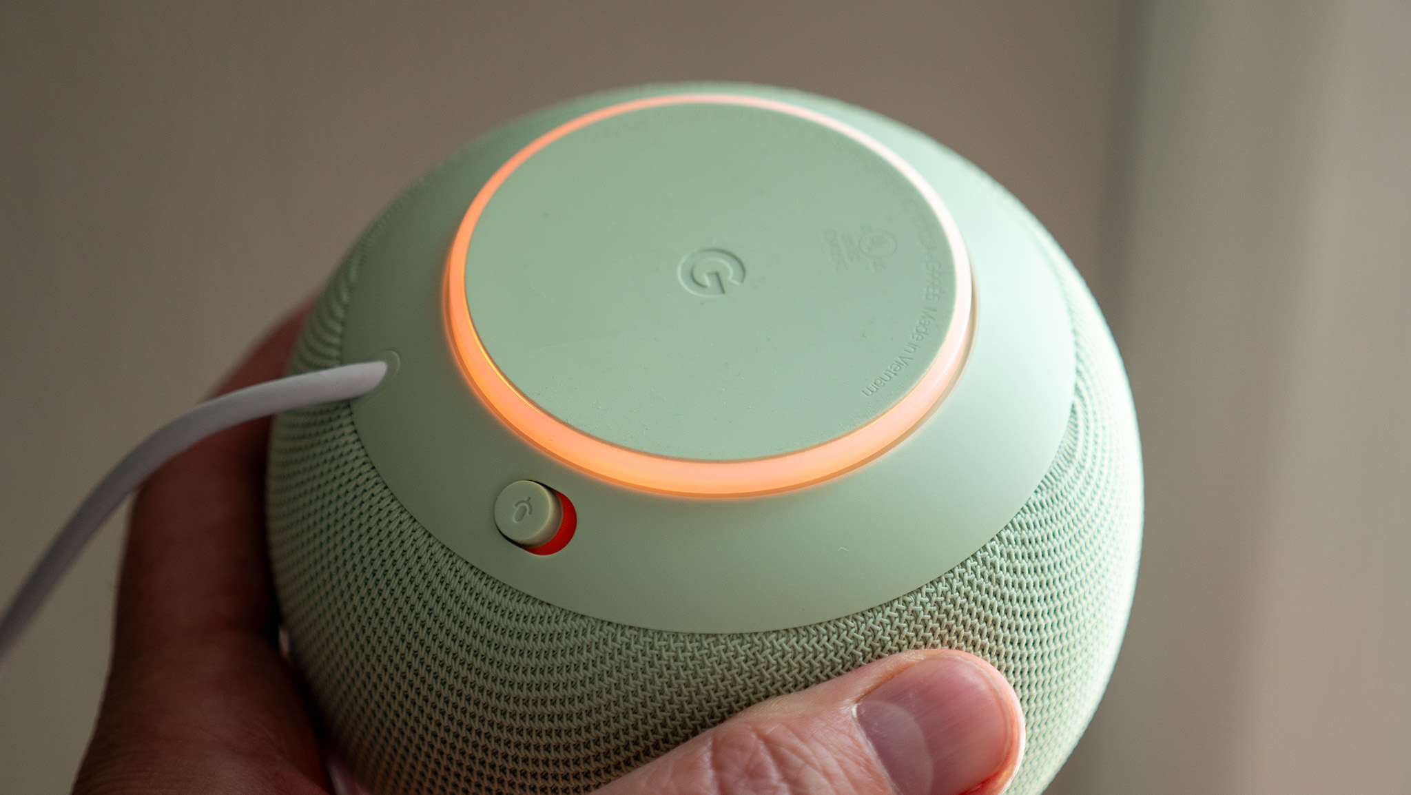 The mute button and amber LEDs on the underside of the Google Home Speaker
