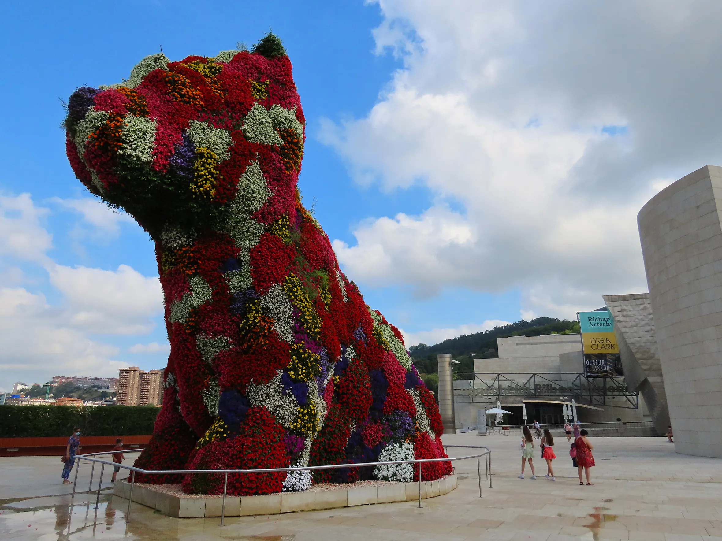 "Puppy," a large, dog-shaped floral sculpture, stands in front of the Guggenheim Museum Bilbao.
