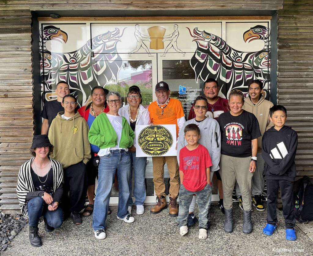 The Ha̲mdzat̓si Collective in front of the “Trials and Tribulations” mural, July 2026. (Dawn Dudek/Contributor)