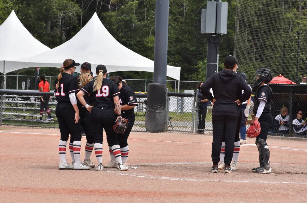 Team Canada confers during their game vs. Czechia Thursday (July 9) in South Surrey’s Softball City, which Canada won in a 10-0 shutout. The Canadian Women’s National Team is now 5-0 in round robin play at the 2026 Canada Cup International Softball Championship. (Tricia Leslie/Peace Arch News)