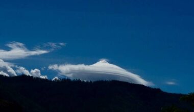 An unusual lenticular cloud drifts above the mountains near Montrose, creating a smooth, layered formation often compared to a flying saucer. (Photos/Cathy Aitken)