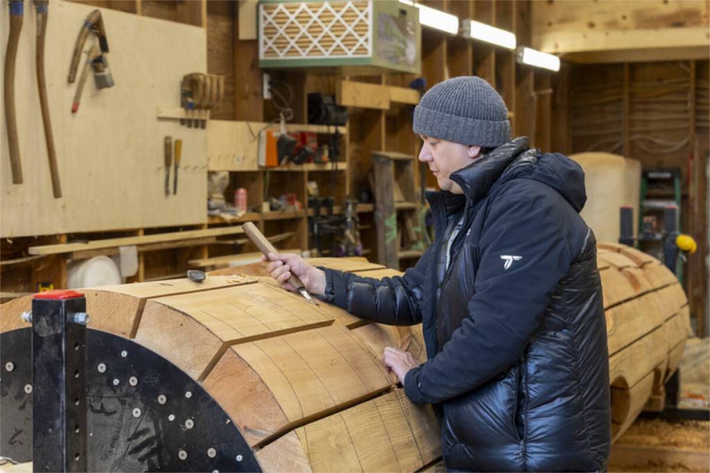 Indigenous artist Carey Newman working with Totem 2.0 in his workshop. (Courtesy Camosun College)