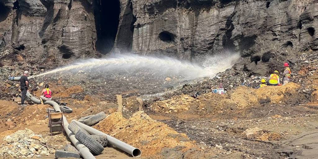 A hydraulic monitor thaws permafrost with high-pressure water in the Klondike goldfields, Yukon. Researchers used these mining exposures to access ancient ground ice and fossil records. Photo courtesy of Duane Froese/CC BY-NC-ND