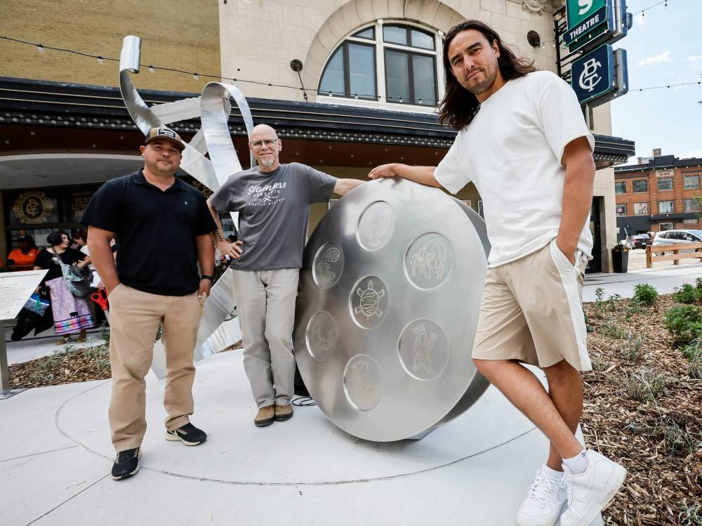 JOHN WOODS / FREE PRESS
From left: Darren Sakwi and Rob Peristry of Stainless Concepts and artist Fredrick Spence with their creation, Gather Your Heart