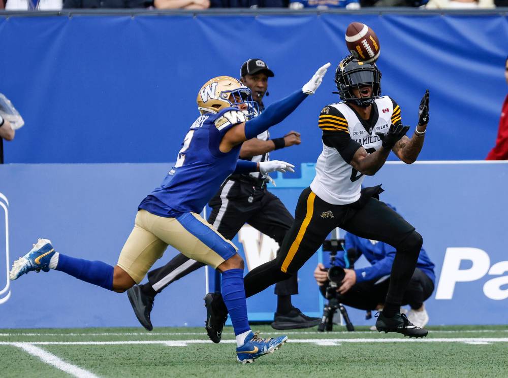 JOHN WOODS / THE CANDIAN PRESS
Winnipeg Blue Bombers’ Jonathan Moxey (2) defends against Hamilton Tiger-Cats’ Keric Wheatfall (8) as he makes the catch during first half CFL football action in Winnipeg on June 11.