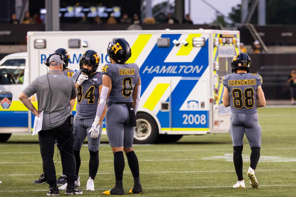 An ambulance carrying Hamilton Tiger-Cats quarterback Bo Levi Mitchell drives off the field during second half CFL football action against the Winnipeg Blue Bombers, in Hamilton on Sunday, July 5, 2026. (Nick Iwanyshyn / The Canadian Press)