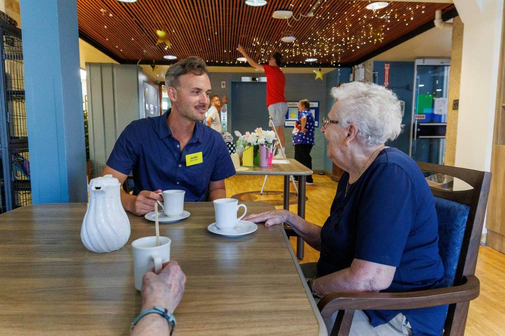 MIKE DEAL / FREE PRESS
CEO Justin Lagace joins Pauline Kolbuck, who turned 101 in May, for tea and a visit. The staff’s mission is to treat all residents like family.