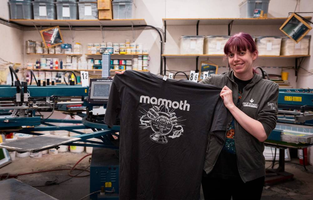 Dorian Preston photo
Samantha Wiebe, art director at HD Graphics, holds a Mammoth rock band tour T-shirt at the company’s headquarters in Île-des-Chênes.
