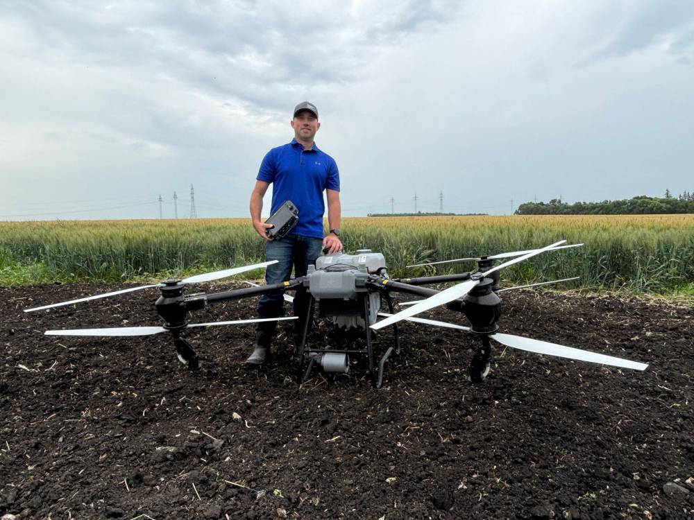 AARON EPP / FREE PRESS
Kevin Falk, a research scientist at Corteva Agriscience Canada Co., with a DJI Agras T50 drone at Innovation Farms in Grosse Isle on Wednesday.