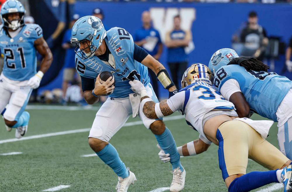 John Woods / THE CANADIAN PRESS
Blue Bombers linebacker Tony Jones pulls down Toronto Argonauts quarterback Chad Kelly in Winnipeg on Friday.