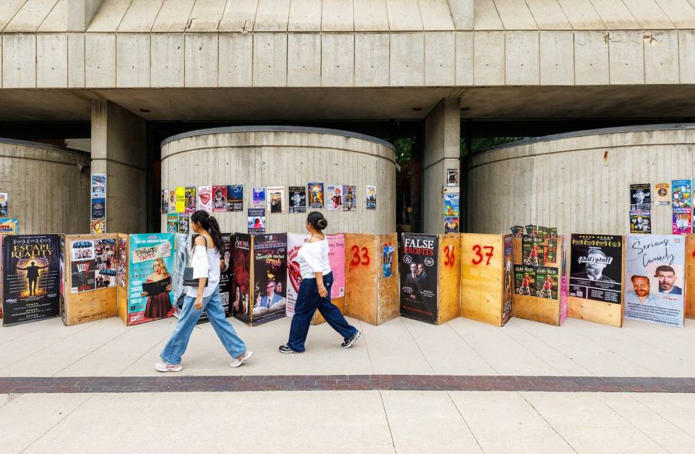 MIKE DEAL / FREE PRESS
Fringe festival posters and sandwich boards line the sidewalk along Market Avenue beside the Royal Manitoba Theatre Centre.