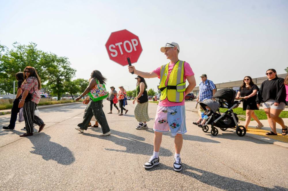 Mike Sudoma / Free Press
Crossing guard Adam Affleck helps with the flow of pedestrian and vehicular traffic during the market’s peak business hours.