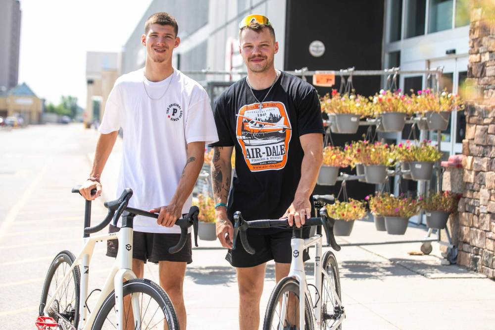 MIKAELA MACKENZIE / FREE PRESS
Thomas Clark (left) and Val Duquenne with their new bikes on Monday. While they were cycling across Canada to raise money for men’s mental health, their bikes were stolen in Winnipeg. Winnipeggers rallied to supply new ones.
