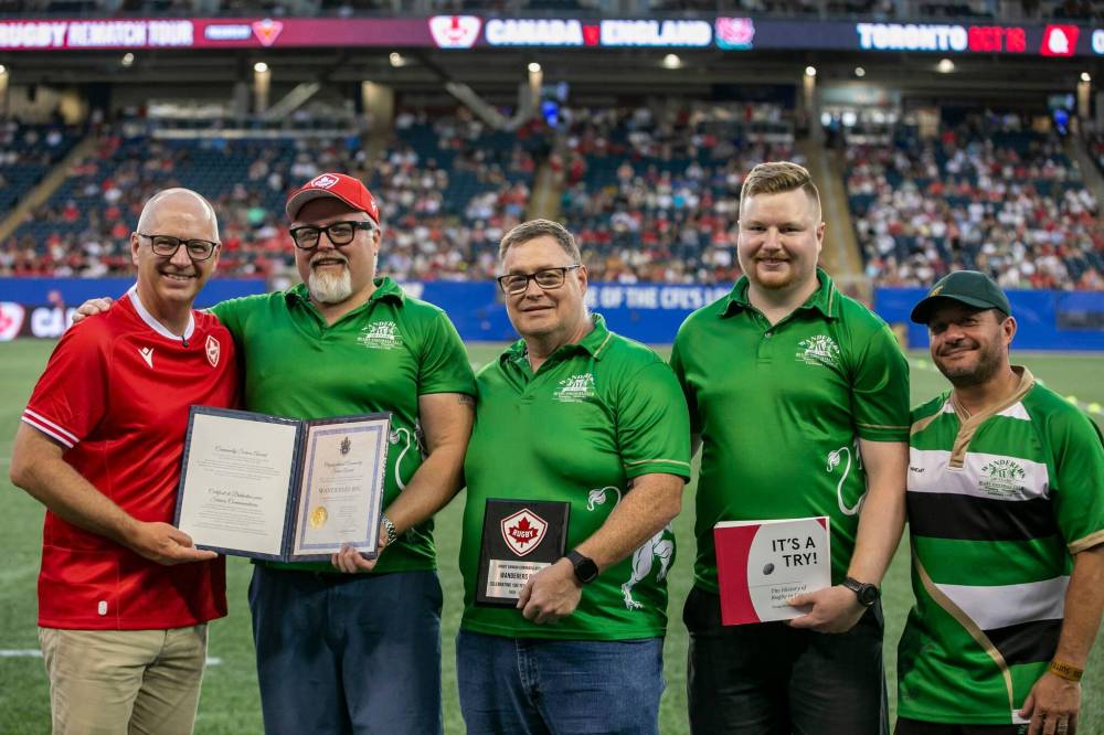 BROOK JONES / FREE PRESS
The Winnipeg Wanderers 100th anniversary was celebrated by Rugby Canada during halftime of the Canada-Zimbabwe match, fitting at the home of the Winnipeg Blue Bombers on July 18. From left: Mayor Scott Gillingham, Wanderers president Brad Hirst, vice-president Dan Fardoe, secretary Turner Green and men’s team head coach Joey Potter.