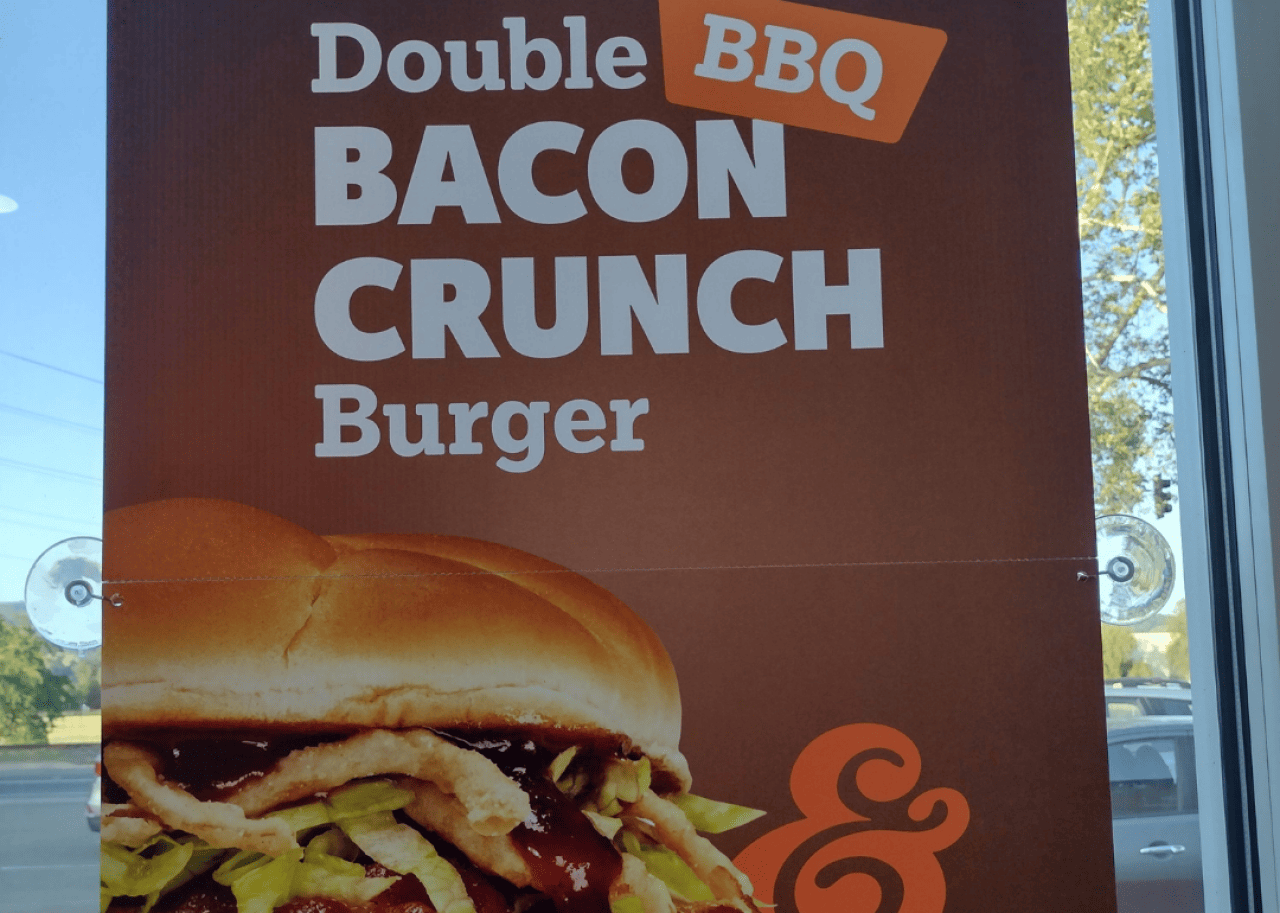 A poster for the BBQ Bacon Crunch Burger at A&W. -