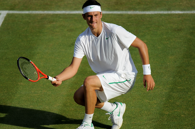 Bernard Tomic returns a shot during his third-round match at Wimbledon in 2011.