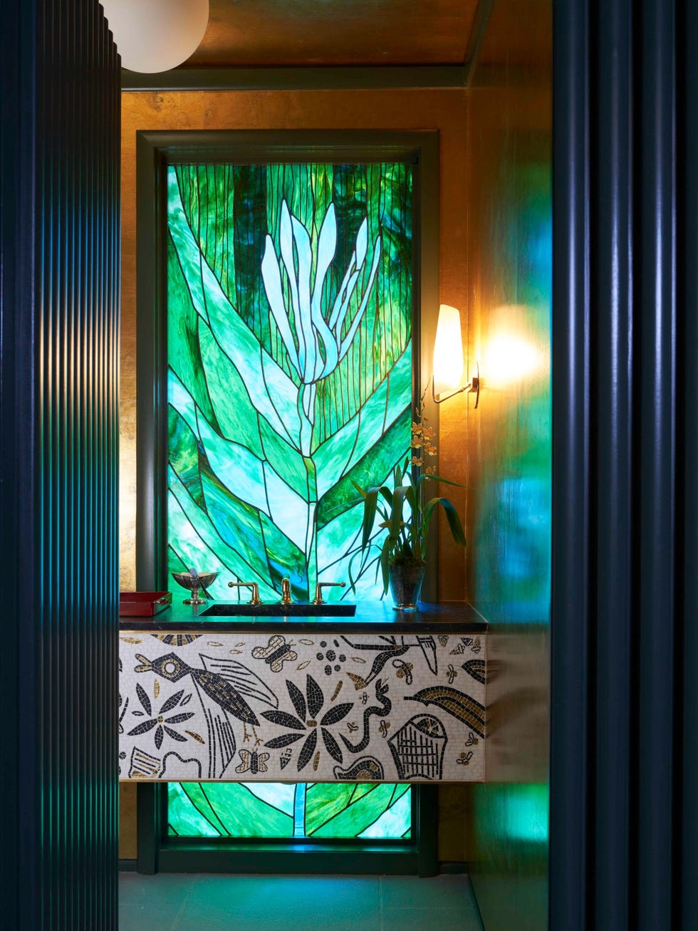 A brightly lit bathroom featuring a vibrant stained glass window and a decorative sink with intricate patterns.