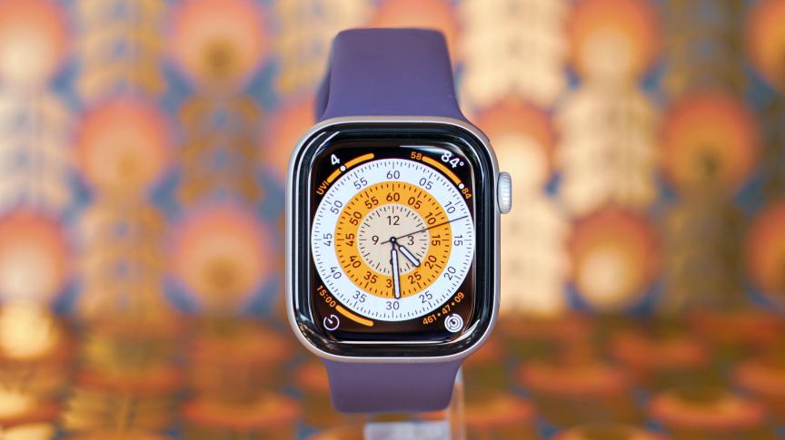 Close-up of an Apple watch face that shows different tracked metrics.