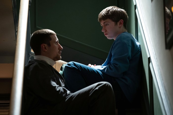 519700,TITLE:EastEnders Barney and Harry sat on a darkened staircase in EastEnders