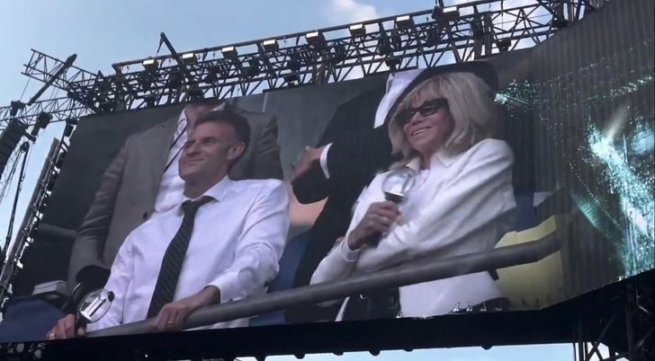 French President Emmanuel Macron and first lady Brigitte Macron are featured on the giant screen during a BTS concert at the Stade de France in Paris, Friday (local time). Captured from X (formerly Twitter)