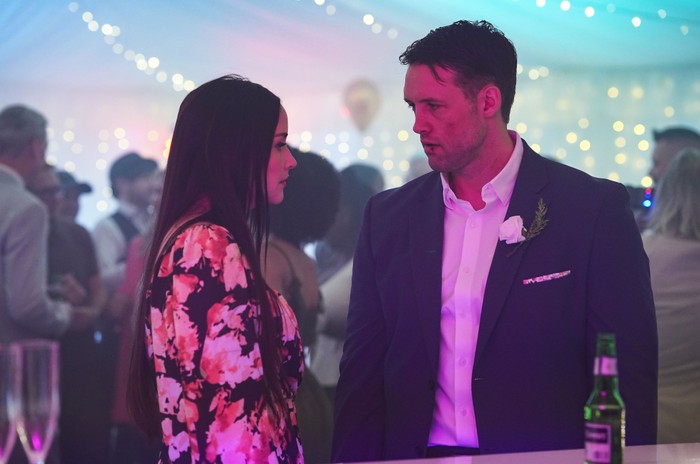 563273,TITLE:Eastenders Jacqueline Jossa as Lauren Beale facing Stephen Aaron-Sipple as Mark Fowler and lit in purple in EastEnders.