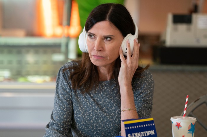 564818,TITLE:Eastenders Bea listens on some headphones in McKlunkys in a scene from EastEnders
