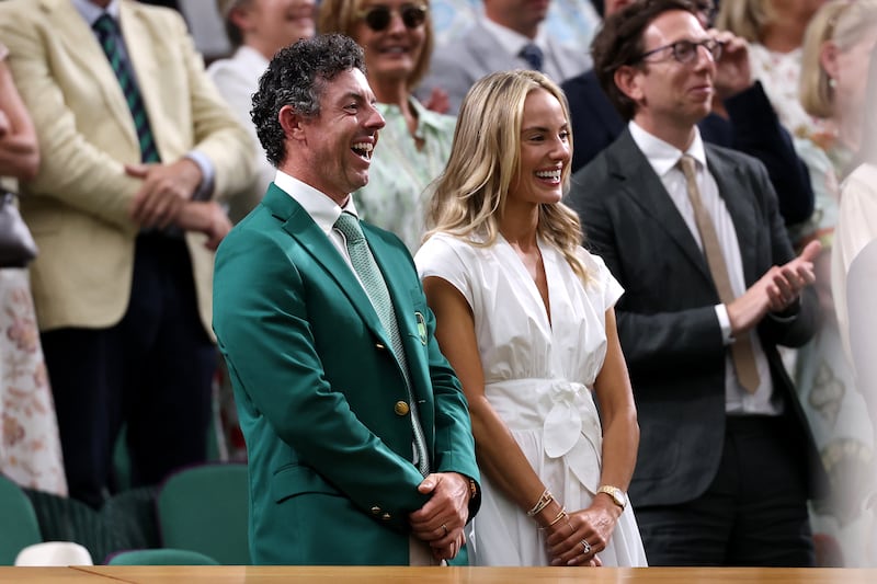 Rory McIlroy in the Royal Box with partner Erica Stoll as Novak Djokovic of Serbia speaks to him during a post-victory speech after defeating Stefanos Tsitsipas of Greece during the men's second round match on day two of Wimbledon. Photograph: Getty Images