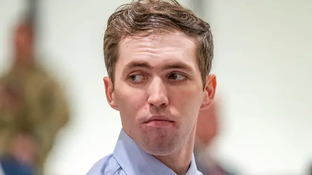 A close shot of Tyler Robinson in a courtroom