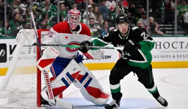 Montreal Canadiens goaltender Sam Montembeault (35) and Dallas Stars center Mavrik Bourque (22) look for the puck during the game between the Stars and the Canadiens at the American Airlines Center.