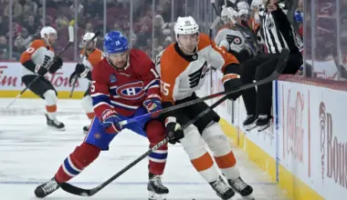 Montreal Canadiens forward Alex Newhook (15) and Philadelphia Flyers defenseman Rasmus Ristolainen (55) chase the puck during the first period at the Bell Centre.