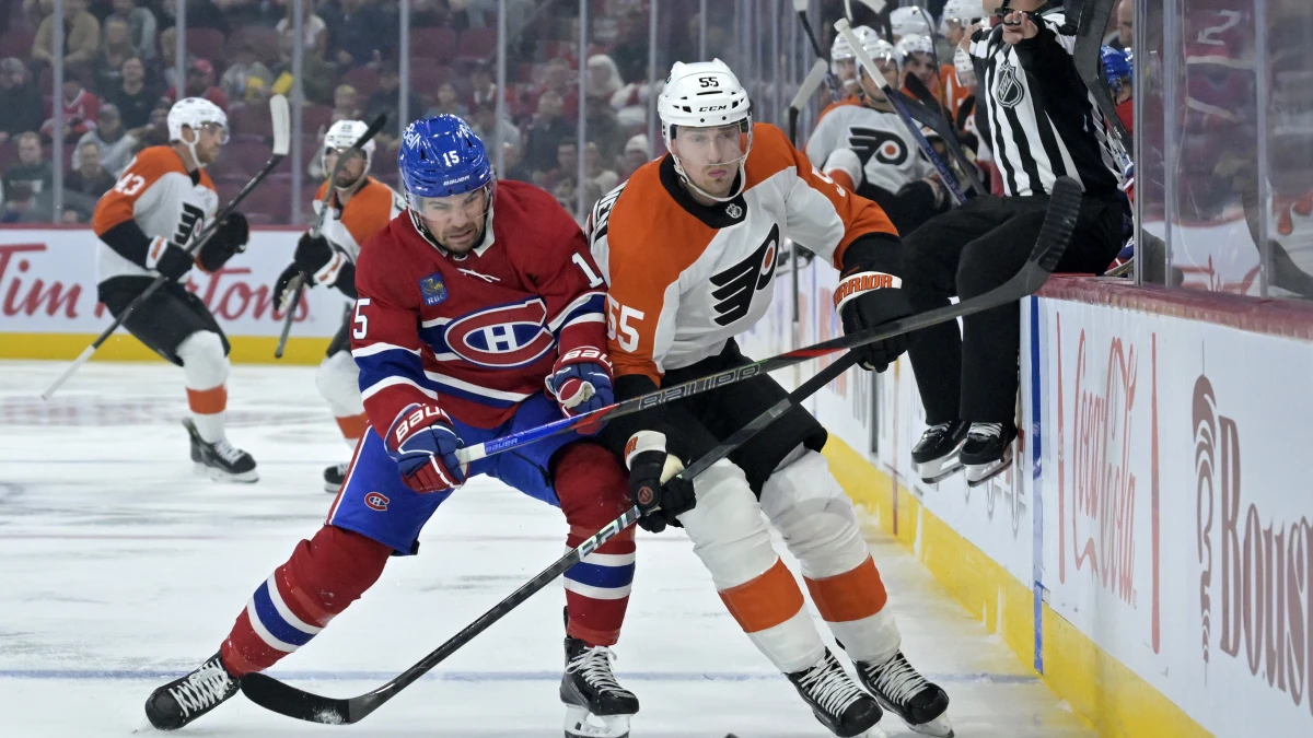 Montreal Canadiens forward Alex Newhook (15) and Philadelphia Flyers defenseman Rasmus Ristolainen (55) chase the puck during the first period at the Bell Centre.