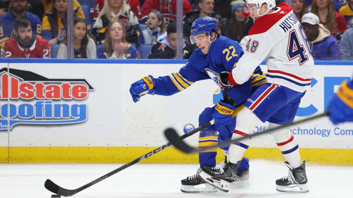 Buffalo Sabres right wing Jack Quinn (22) tries to control the puck as Montr&eacute;al Canadiens defenseman Lane Hutson (48) defends during the third period at KeyBank Center.