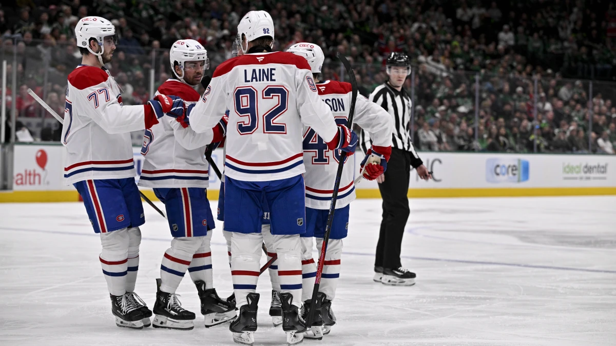 Montreal Canadiens center Alex Newhook (15) and left wing Patrik Laine (92) and defenseman Lane Hutson (48) and center Kirby Dach (77) celebrates a goal scored Newhook against the Dallas Stars during the third period at the American Airlines Center.