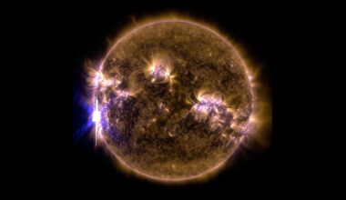 A filtered sun that's yellow and purple. A solar flare is visible to the left.
