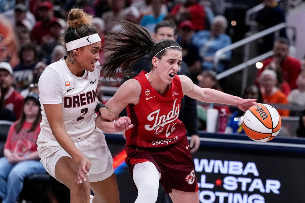 Indiana Fever guard Caitlin Clark (22) drives on Atlanta Dream guard Te-Hina Paopao (2) in the first half of a WNBA basketball game in Indianapolis, Thursday, June 18, 2026. (AP Photo/Michael Conroy)