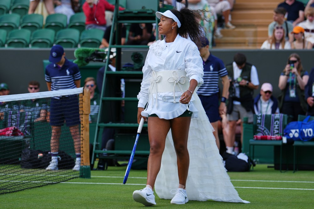 Naomi Osaka of Japan enters the court for the second round women's singles match against Anastasia Gasanova of Russia at the Wimbledon Tennis Championships in London, Wednesday, July 1, 2026.(AP Photo/Kirsty Wigglesworth)