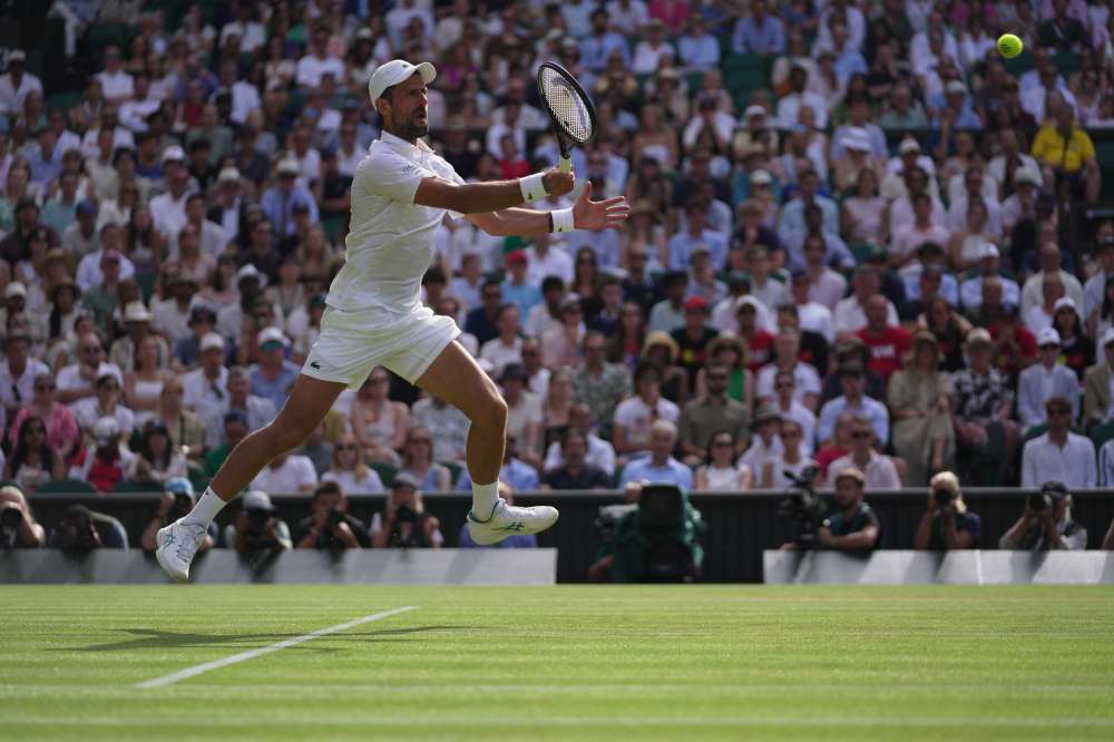 Novak Djokovic of Serbia returns the ball to Roman Saffiulin of Russia in their fourth round men's singles match at the Wimbledon Tennis Championships in London, Sunday, July 5, 2026. (AP Photo/Brian Inganga)