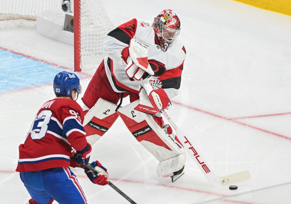 Carolina Hurricanes goaltender Frederik Andersen (31) clears the puck as Montreal Canadiens' Ivan Demidov (93) moves in during the third period of Game 4 of the NHL Eastern Conference playoff series in Montreal on Wednesday, May 27, 2026. THE CANADIAN PRESS/Graham Hughes