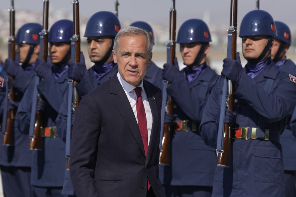 Prime Minister Mark Carney passes an honour guard as he disembark a government plane in Ankara, Turkey, Tuesday, July 7, 2026. THE CANADIAN PRESS/Adrian Wyld