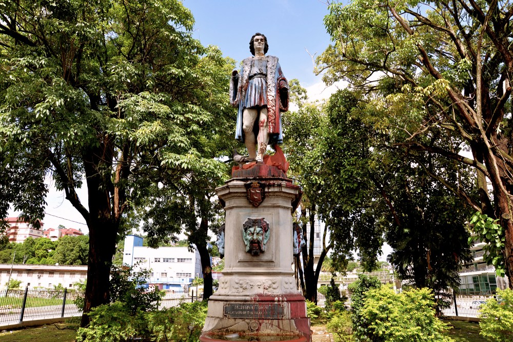 FILE - A vandalized statue of Christopher Columbus towers over Columbus Square in Port of Spain, Trinidad and Tobago, on Aug. 28, 2024. (AP Photo/Robert Taylor, File)