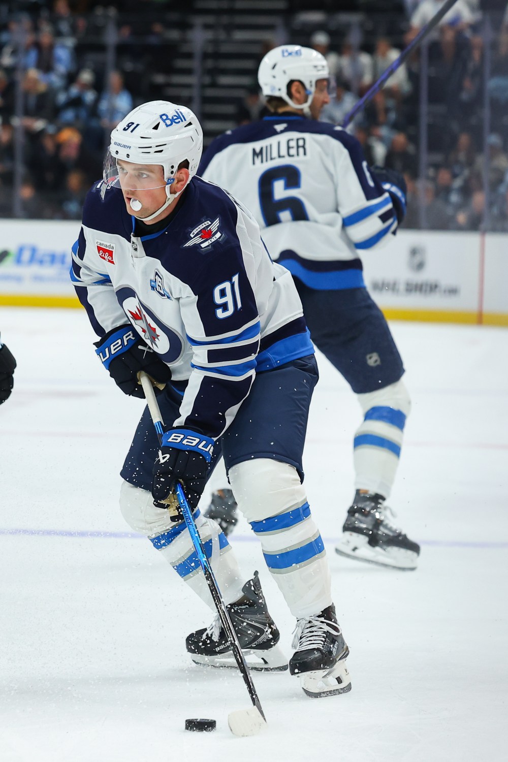 Winnipeg Jets center Cole Perfetti (91) looks to move the puck during the third period of an NHL hockey game against the Utah Mammoth, Tuesday, April 14, 2026, in Salt Lake City. (AP Photo/Melissa Majchrzak)