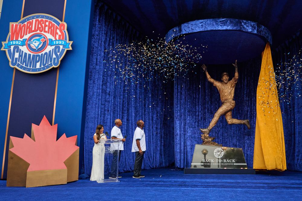 Toronto Blue Jays' Joe Carter, right, and former manager Cito Gaston look on at the unveiling of a statue commemorating the Toronto Blue Jays' 1992 and 1993 World Series wins ahead of MLB baseball action against the Chicago White Sox in Toronto, on Saturday, July 18, 2026. THE CANADIAN PRESS/Sammy Kogan