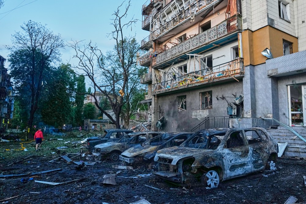 Local residents wander among debris following a Russia missile attack in Kyiv, Ukraine, Sunday, July 19, 2026. (AP Photo/Efrem Lukatsky)