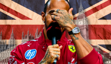 Hamilton holding F1 mic in Ferrari merch with hand covering face in front of union jack and London landscape background