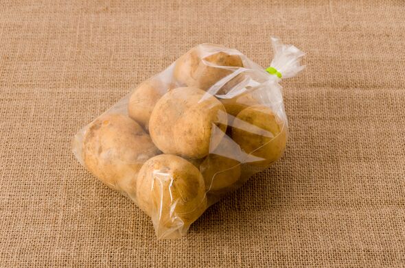 potato in a Plastic bag on burlap background potato in a Plastic bag on burlap background