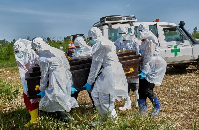 Red Cross workers prepare to lower the coffin of Dr Tibenderana Katho Blaise who worked at the Centre Medical Evangelique (CME) in Hoho commune and died of Ebola virus, at the Nyamurongo cemetery in Bunia town, Ituri province, Democratic Republic of Congo, May 26, 2026.