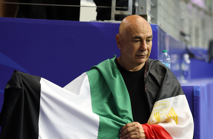 Hossam Hassan, Head Coach of Egypt, holds the flag of Palestine after the team's victory through the penalty shootout during the FIFA World Cup 2026 Round of 32 match between Australia and Egypt at Dallas Stadium on July 03, 2026 in Arlington, Texas.