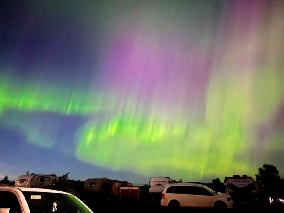 Brilliant bands of the aurora borealis shimmer across the night sky over Aurora during a summer light display. Photo Jennifer Peddle-Morey