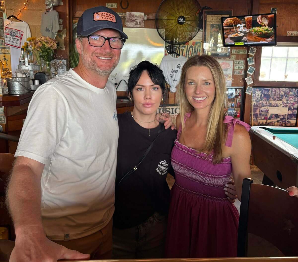 Dale Earnhardt Jr. and his wife Amy pose with bartender Amber Parker, center, at The Fillin’ Station on Lady’s Island Monday. Amber’s grandfather owned The Fillin’ Station when it was a gas station years ago.